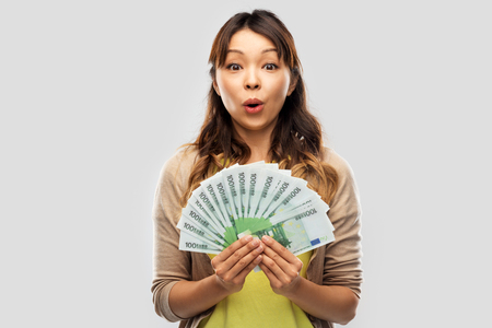 asian woman with hundred euro money banknotesの写真素材