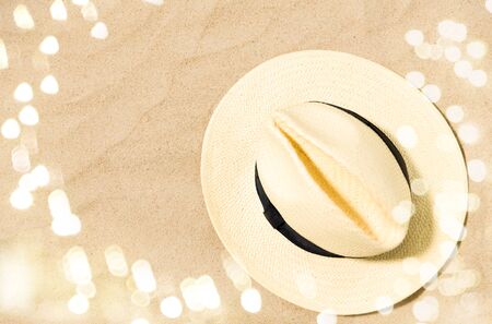 straw hat on beach sandの写真素材