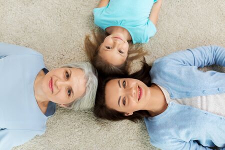mother, daughter and grandmother lying on floor
