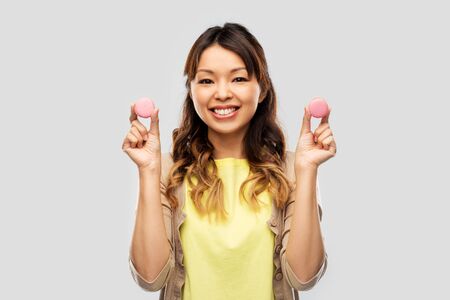 happy asian woman with macaronsの写真素材