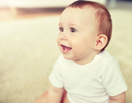 close up of happy little baby boy or girl at home
