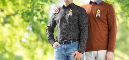 lgbt, same-sex relationships and homosexual concept - close up of male couple with gay pride rainbow...