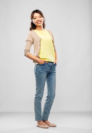 happy asian woman over grey backgroundの写真素材