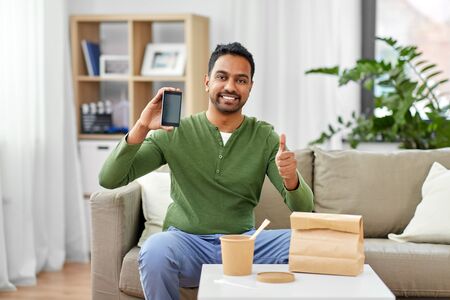indian man using smartphone for food deliveryの写真素材