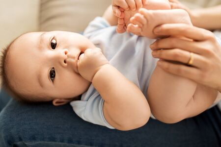 Close up of little Asian baby boy and mother