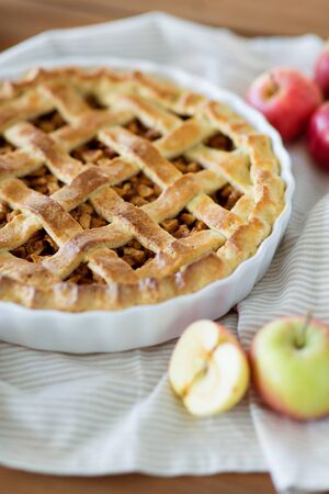 close up of apple pie in baking mold on towelの写真素材