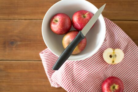 apples and kitchen knife on towelの写真素材