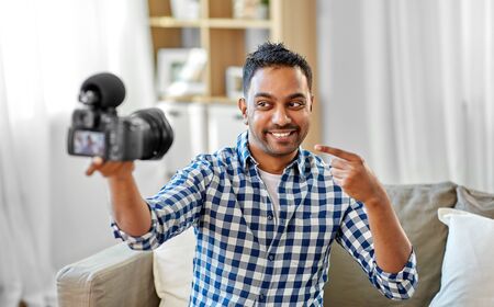 male video blogger with camera blogging at homeの写真素材