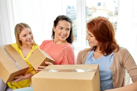 teenage girls or friends with parcel boxesの写真素材
