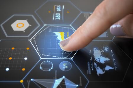 finger on touch screen with virtual charts