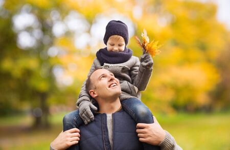 Happy family having fun in autumn parkの写真素材