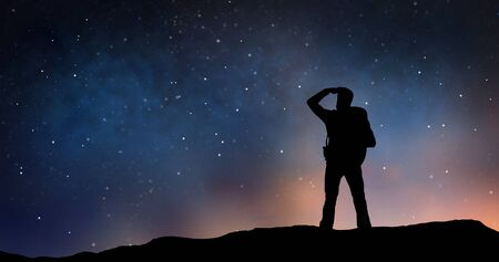 traveler standing on edge and looking far away