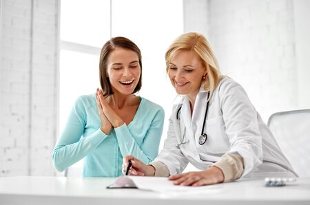 Doctor happy woman patient at hospitalの写真素材