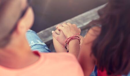 Close up of happy teenage couple handsの写真素材
