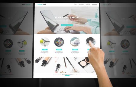 Hand navigating online shop on interactive panel
