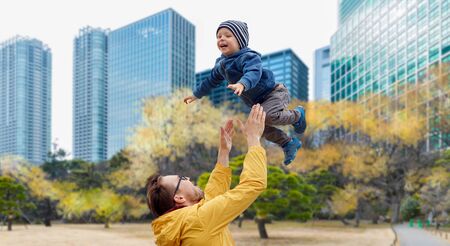 father with son having fun in autumn tokyo city