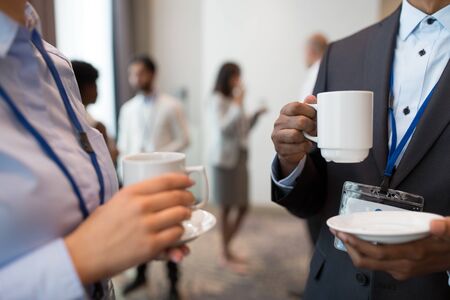 business people with conference badges and coffeeの写真素材