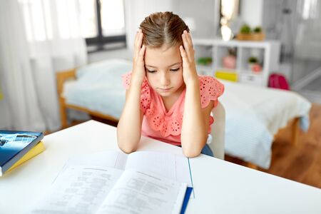 sad student girl with notebook at home