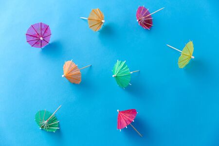 cocktail umbrellas on blue background