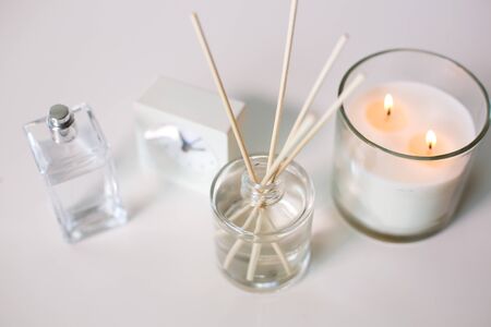 aroma reed diffuser, burning candle and perfume