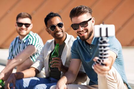 men drinking beer and taking selfie by smartphone