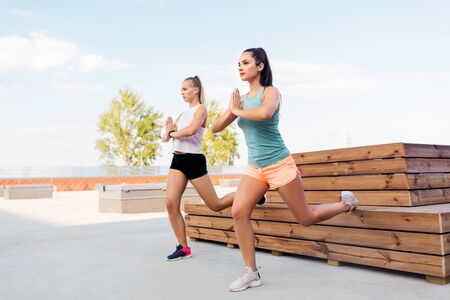 women training and doing split squatsの写真素材