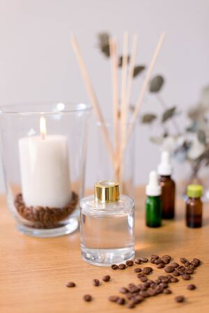 Aroma reed diffuse, burning candle and essential oil on table at homeの写真素材