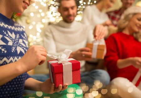 close up of friends opening christmas giftsの販売画像