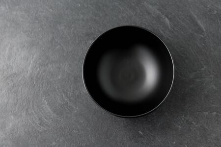 black ceramic plate on slate backgroundの写真素材