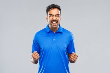 happy indian man celebrating victory