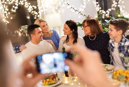 family having dinner party and taking selfie