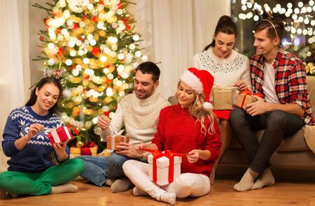 friends celebrating christmas and opening presents