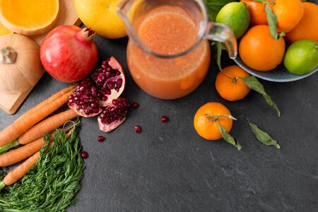 glass jug of juice with fruits and vegetablesの写真素材