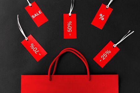 red shopping bag and tags with discount signs