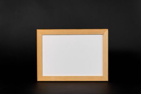 white board in wooden frame on black background