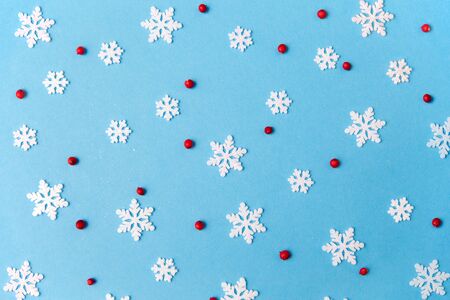 white snowflakes and berries on blue backgroundの写真素材