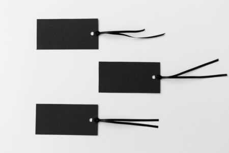 shopping, sale and marketing concept - three black tags on white background