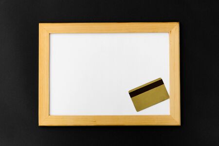white magnetic board and credit card on black