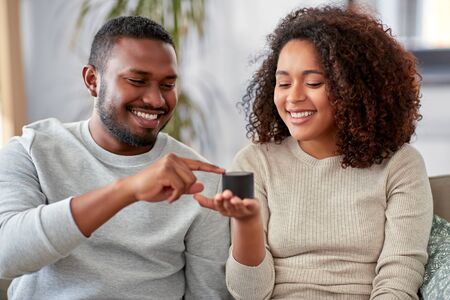 african american couple with smart speaker at homeの写真素材