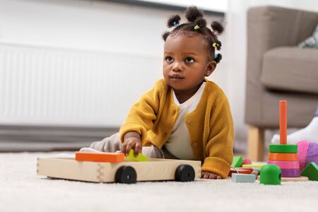 african baby girl playing with toy blocks at homeの写真素材