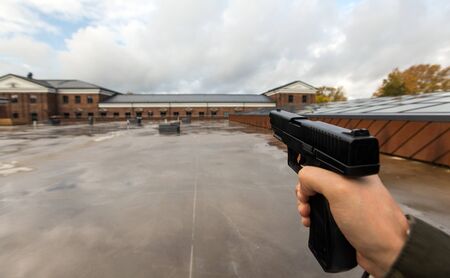 POV of male hands shooting with semi-automatic gunの写真素材