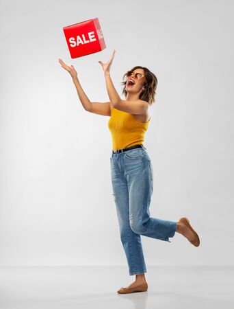 happy smiling young woman posing with sale signの写真素材