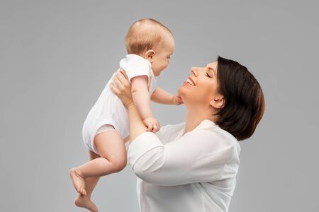 happy middle-aged mother with little baby daughterの写真素材