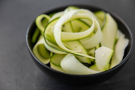 peeled or sliced zucchini in ceramic bowlの写真素材