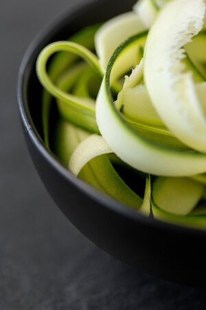 peeled or sliced zucchini in ceramic bowlの写真素材