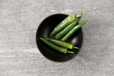 close up of green chili peppers in bowlの写真素材