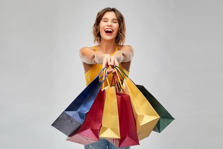happy smiling young woman with shopping bagsの写真素材