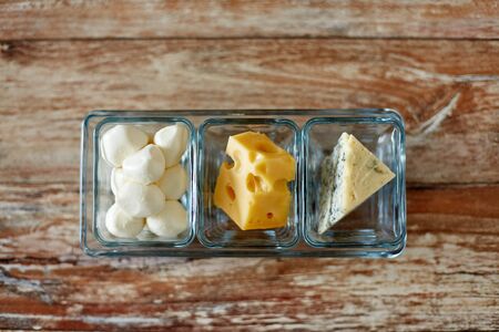 different kinds of cheese in glass cupsの写真素材