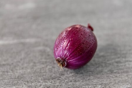 close up of red onion on slate stone backgroundの写真素材