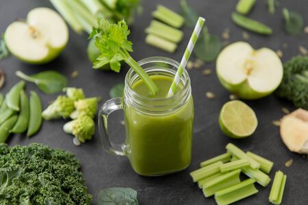 close up of glass mug with green vegetable juiceの写真素材